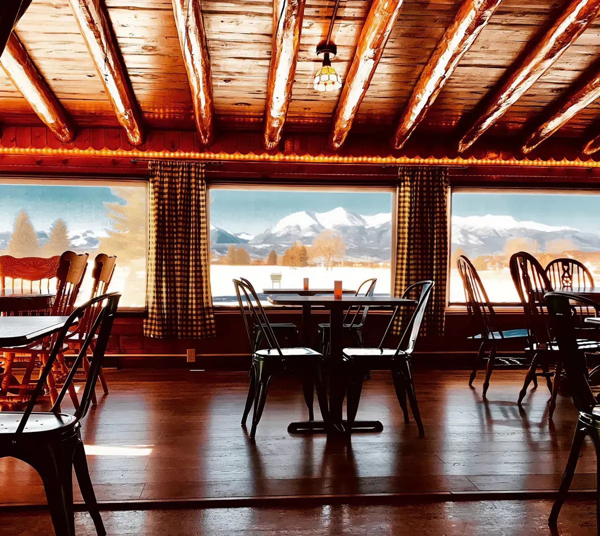 Cozy cabin dining with snowy mountain view