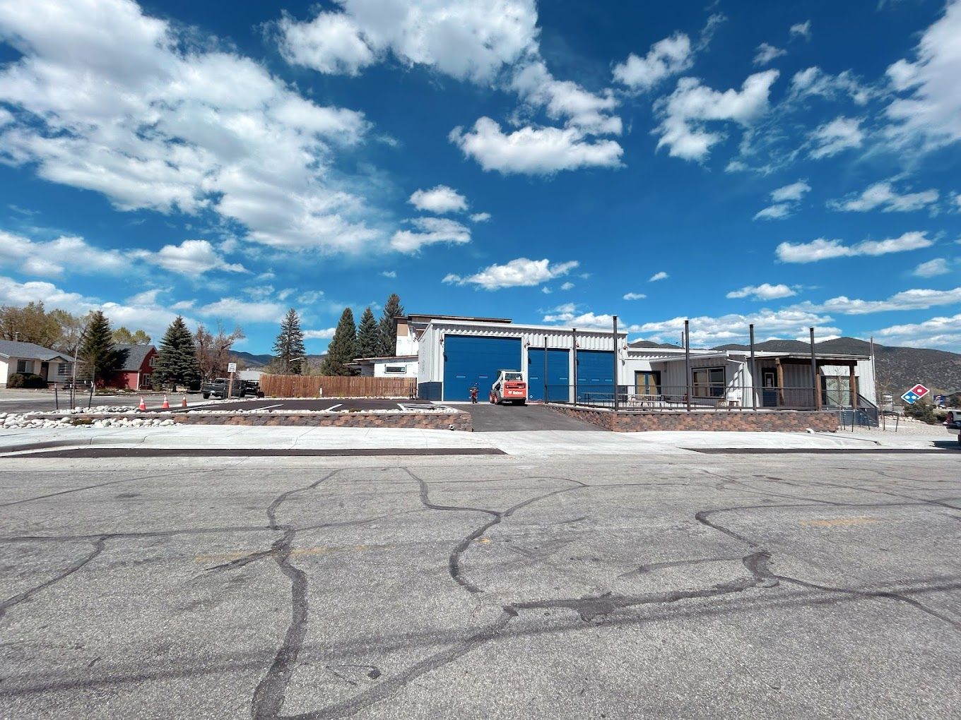 Warehouse with open area and parked cars